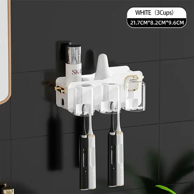 White toothbrush holder with three clear cups and gold-tone accents for toiletries in decorbites inverted toothbrush holder