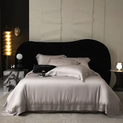 Silk satin duvet cover bedding set in soft light gray with elegant piping made from lyocell eucalyptus fiber