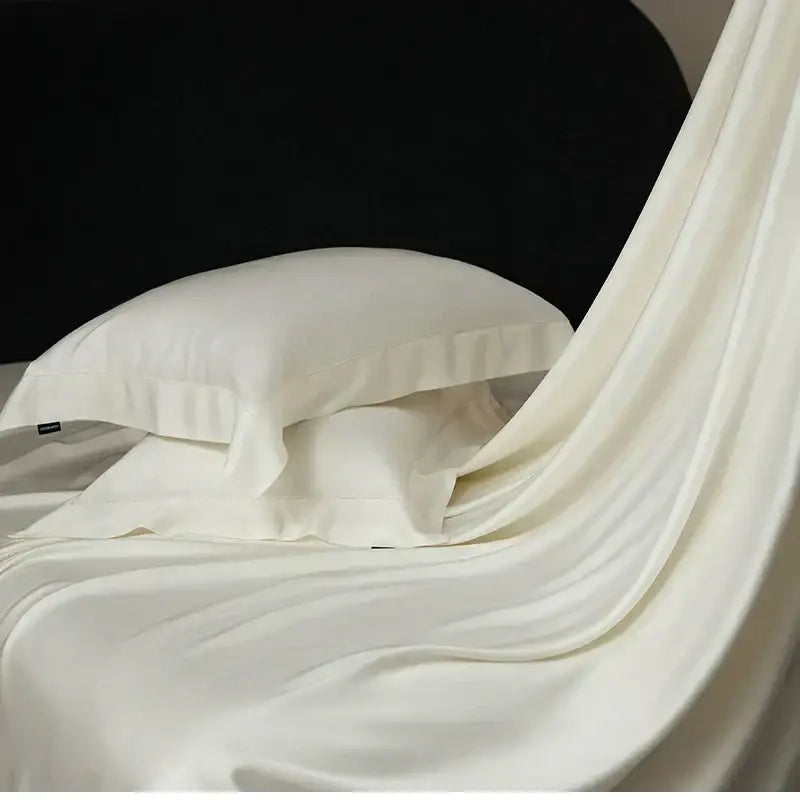 Cream-colored satin pillowcase with ruffled edge from black velvet lyocell eucalyptus fiber bedding set for luxury bedroom