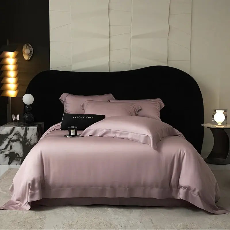 A soft lavender satin duvet set with elegant stitched edges made from lyocell eucalyptus fiber for luxury bedding use