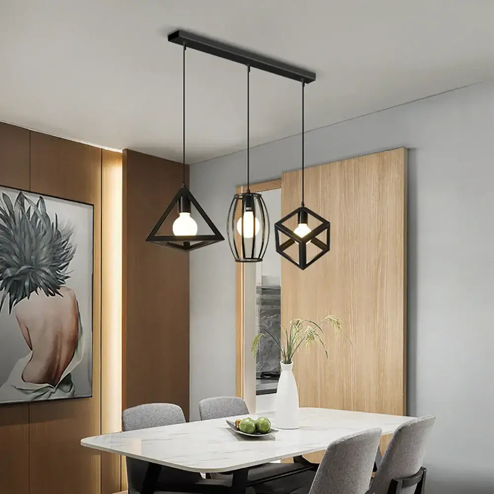 Black geometric pendant light with exposed bulbs hanging from a base canopy plate for dining room use