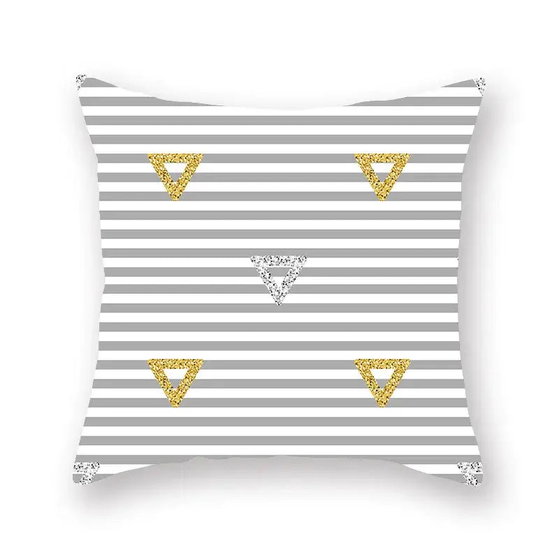 A square throw pillow with a gray and white geometric star stripe pattern and glittery gold and silver accents