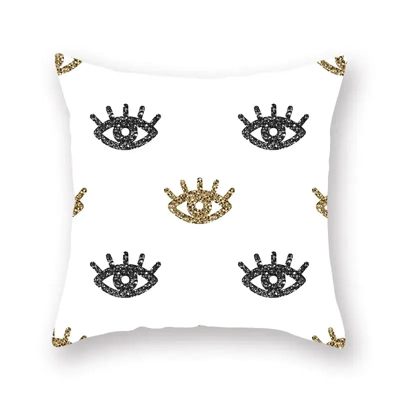 White throw pillow with black and gold glittery eye motifs featuring geometric star stripe print for bedroom decor