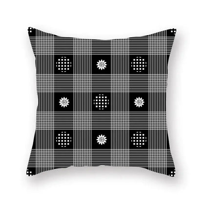 Black and white plaid throw pillow with sunflower and checkered circle pattern featuring geometric star stripe design