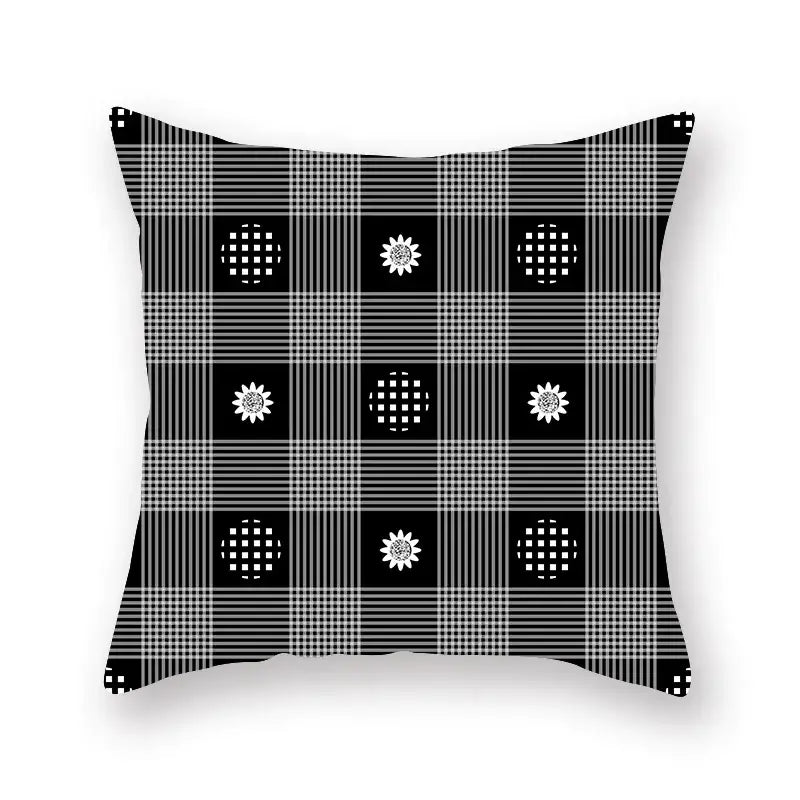 Black and white plaid throw pillow with sunflower and checkered circle pattern featuring geometric star stripe design