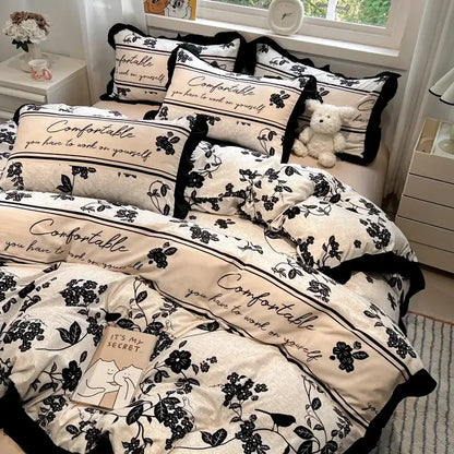 Cream-colored cream black white printed bedding set with floral and script patterns and ruffled edges by decorbites black white