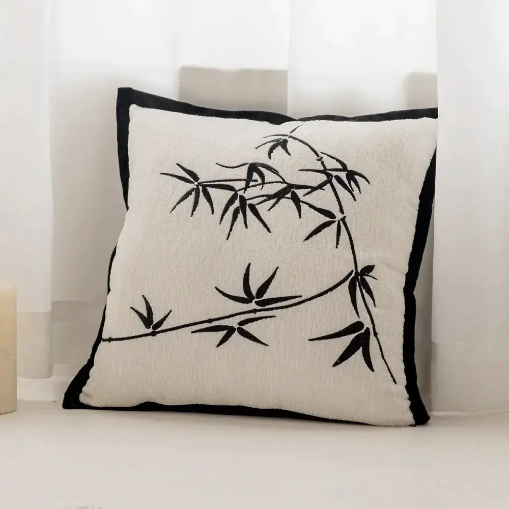 Cream-colored cushion cover with black embroidered bamboo and black border in decorbites knitted crochet living room decor