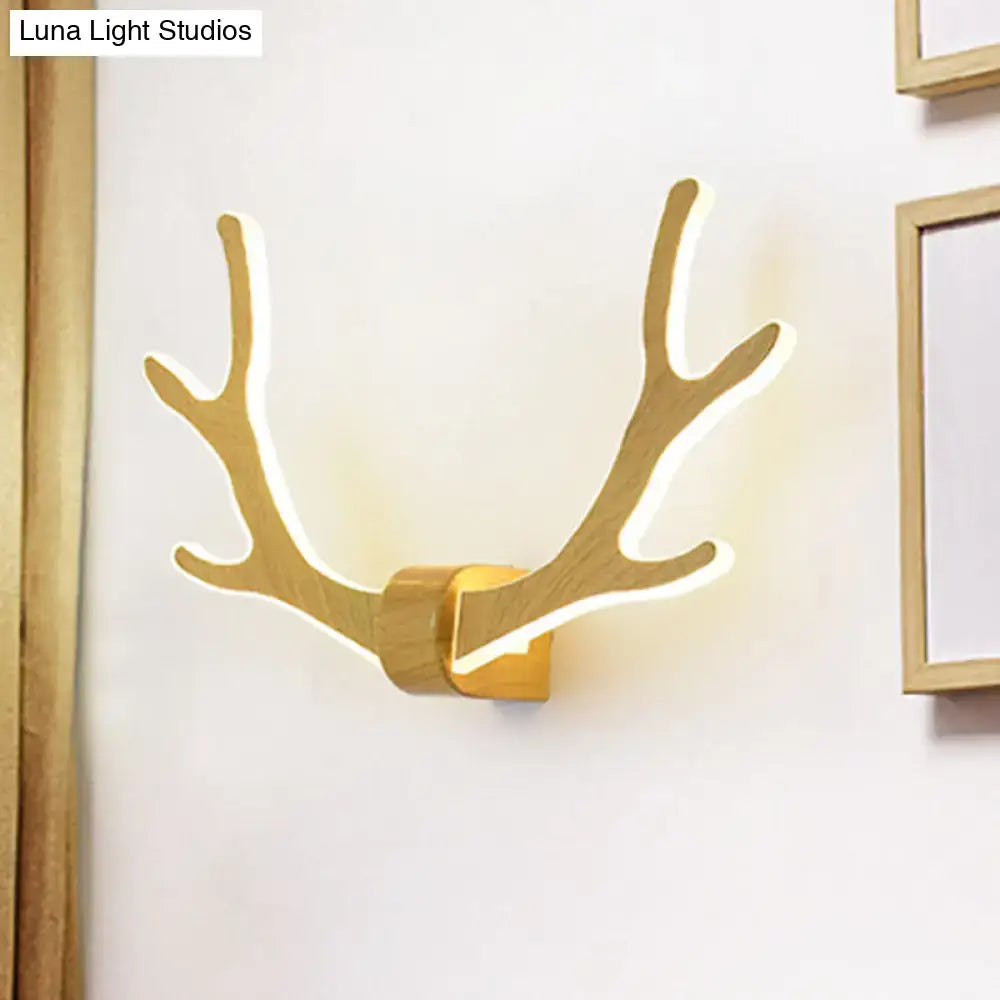 Golden wooden antler wall sconce with integrated warm led lighting designed as a decorative wall lamp for corridors