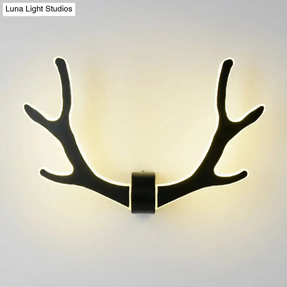 Black wooden antler wall lamp with illuminated edges providing warm led lighting for corridor use