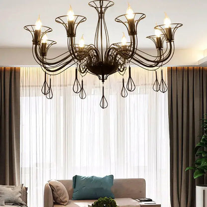 Black wrought iron chandelier with intricate swirling arms and teardrop pendants for elegant dining room decorbites black wrought