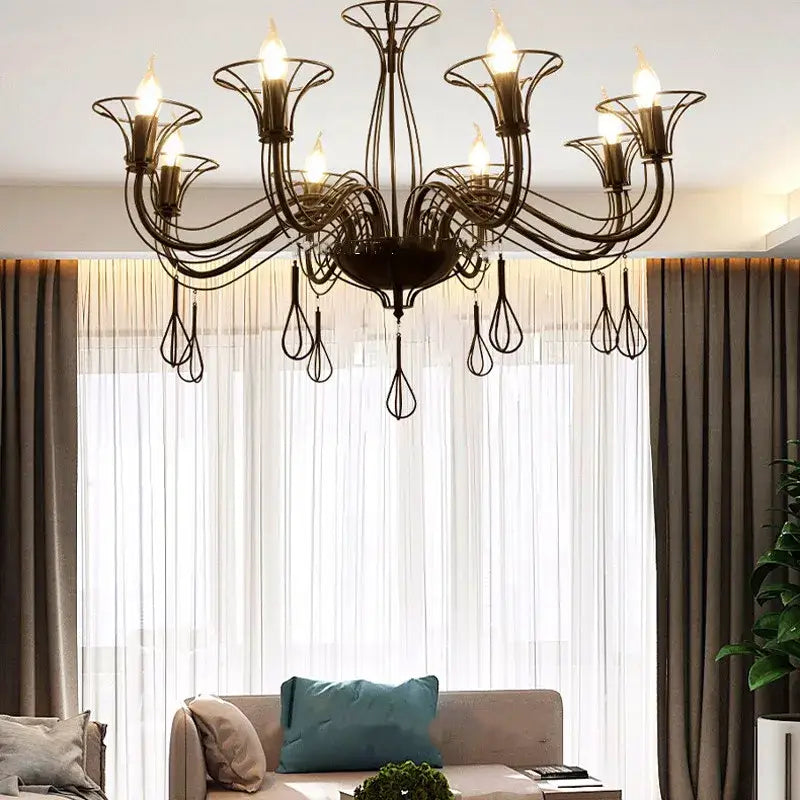 Black wrought iron chandelier with intricate swirling arms and teardrop pendants for elegant dining room decorbites black wrought