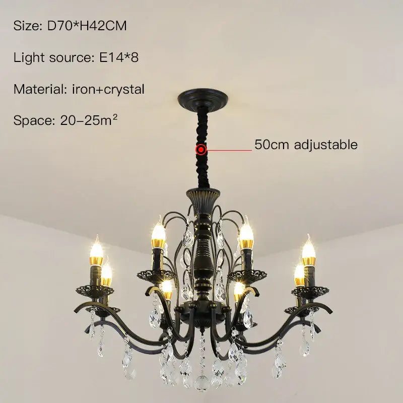 Black wrought iron chandelier with crystal droplets and candle style lights for dining room lighting