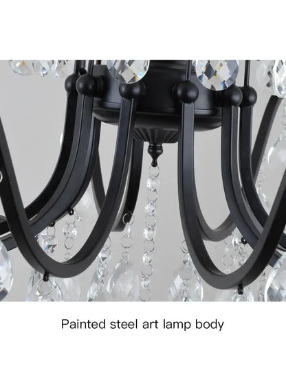 Black wrought iron chandelier with crystal droplets and faceted accents for dining room lighting