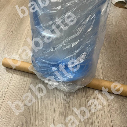 A blue plastic water jug wrapped in clear plastic featured with decorbites™ blonde ocean poster prints for home decor