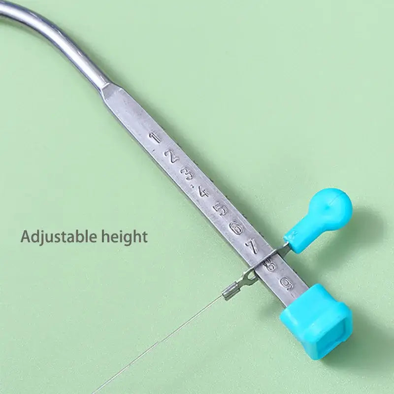 Silver metal adjustable height wire cutter with turquoise handles for decorbites cake slicer baking tool use