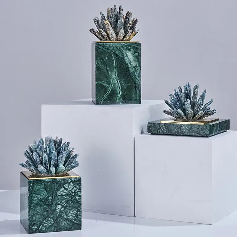 Green marble bases with gold-trimmed tops holding spiky dark gray white agate stone crystal sculptures decorbites agate stone