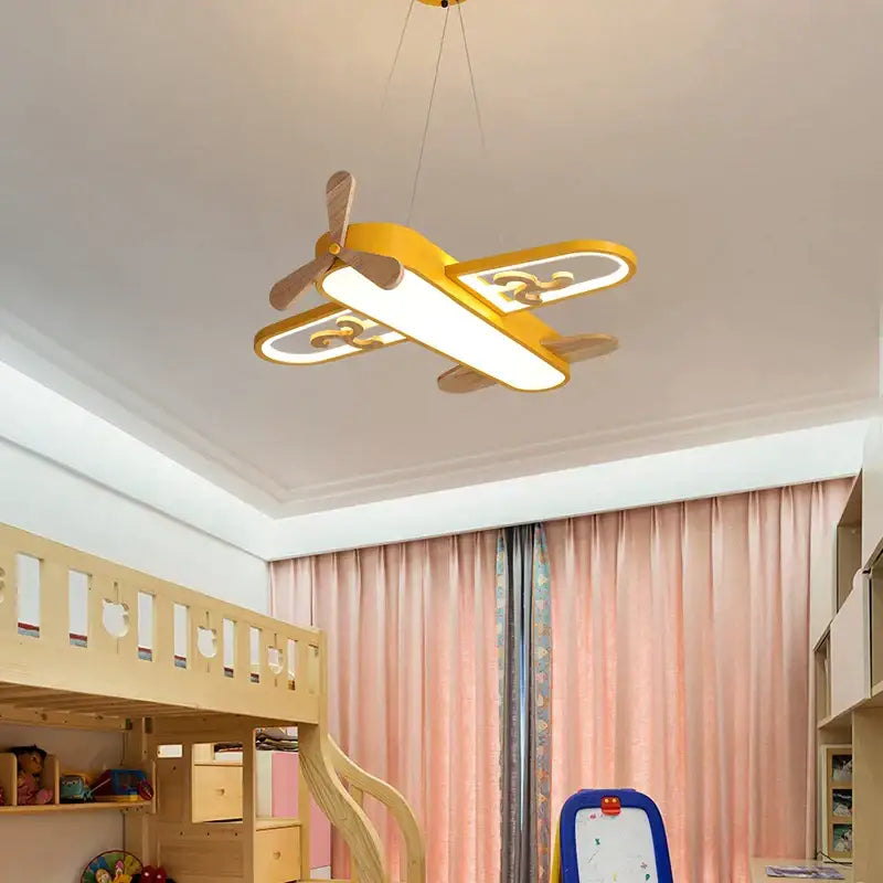 Yellow airplane-shaped led wood ceiling light with wooden propeller and wings by decorbites for kids bedroom decor
