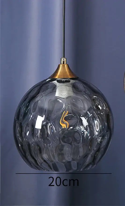 A 20cm decorbites glass ball pendant with textured dark gray glass and gold-toned fixture for kitchen chandelier