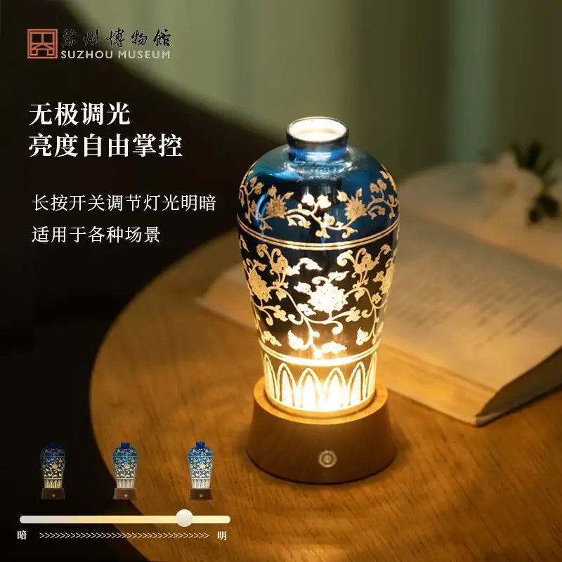 A blue and gold ceramic vase night light table lamp with intricate floral patterns illuminated warmly by decorbites liuguang qingying
