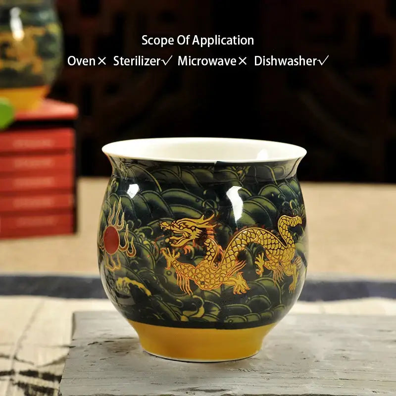 Black ceramic tea cup with gold dragon and cloud motifs white interior yellow base from decorbites dragon teapot tea set
