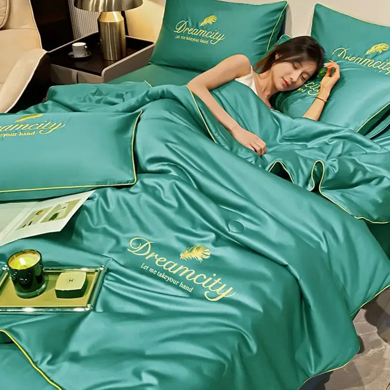 Teal satin quilt set with gold embroidery leaf motif by dreamcity made of embroidered ice silk summer fabric