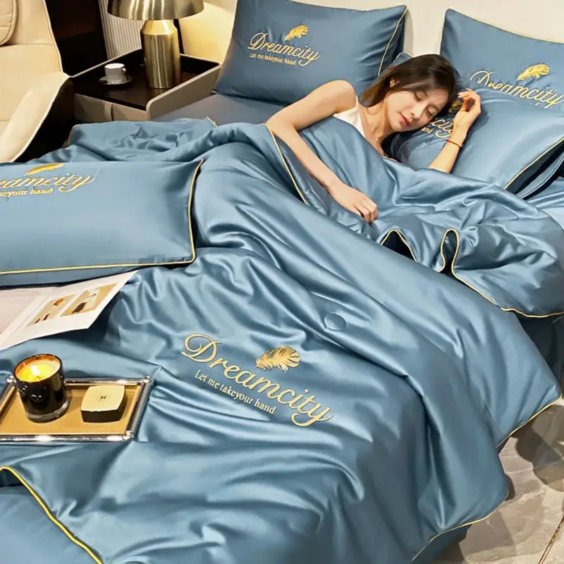 Blue and gold embroidered ice silk quilt set with dreamcity brand name and leaf motif for ice silk summer use