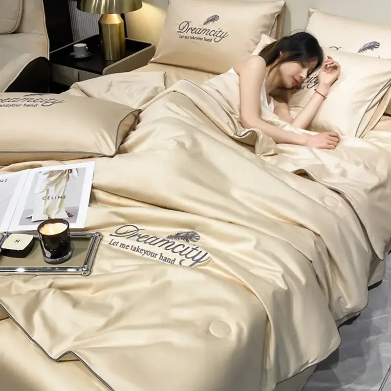 Cream-colored satin quilt set with embroidered dreamcity and feather design in blue and gold ice silk summer style