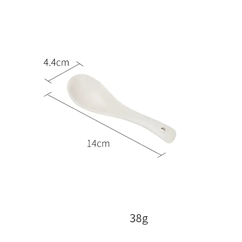 White ceramic rice spoon with smooth rounded bowl and slender handle in blue and gray decorbites ceramic morandi bowl set