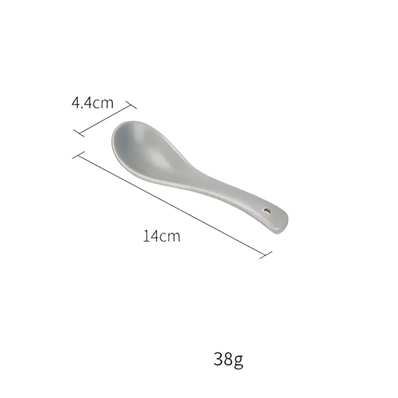 A sleek matte gray ceramic morandi spoon with a tapered handle and hole in the decorbites ceramic morandi collection
