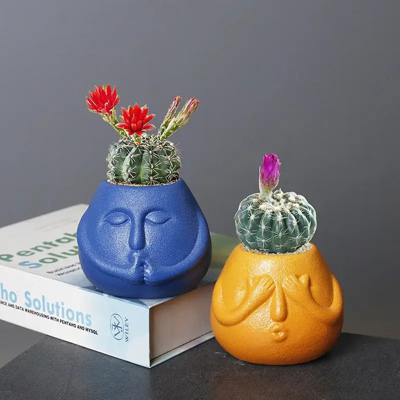 Blue and orange ceramic abstract human face planters with closed eyes for living room decorbites ceramic abstract decor
