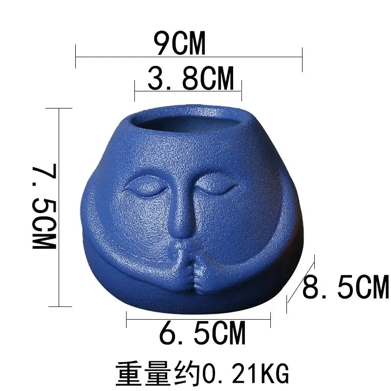 Blue and orange ceramic abstract human face planter with serene closed eyes for living room decorbites ceramic abstract use