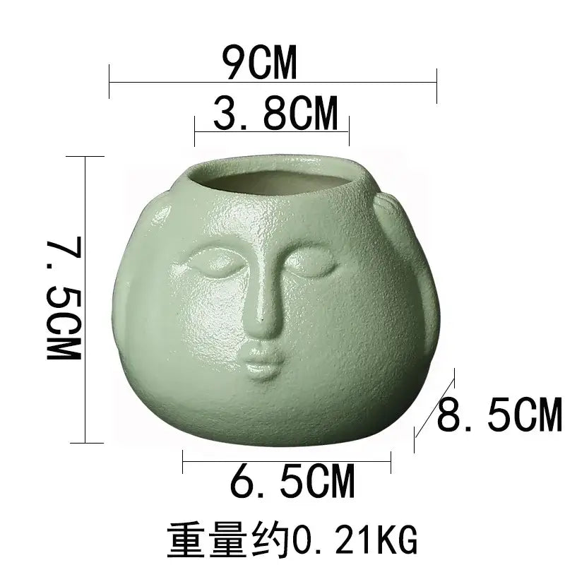 Matte sage green ceramic abstract human face planter with serene features for living room decorbites ceramic abstract decor