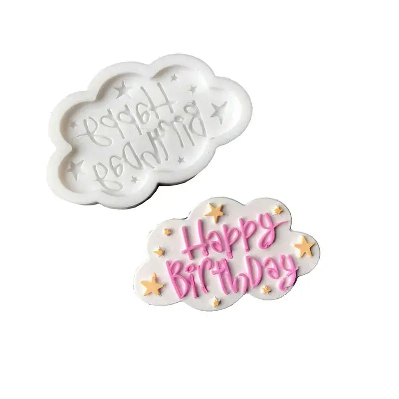 White cloud-shaped silicone mold with happy birthday design and pink lettering and gold star decorbites birthday cake piece