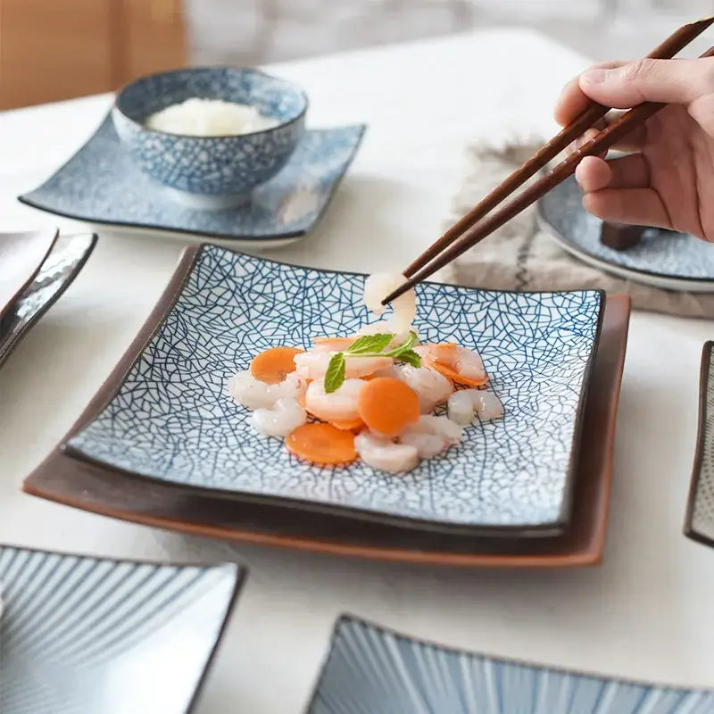 Blue ceramic porcelain square dinner plate with crackled glaze and dark brown rim in modern minimalist design