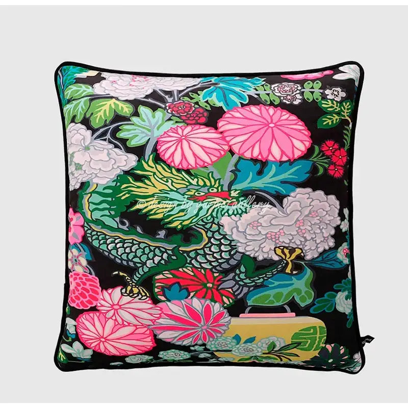 Blue and white crane throw pillow case with vibrant floral and dragon pattern featuring pink green red and white blossoms on black background