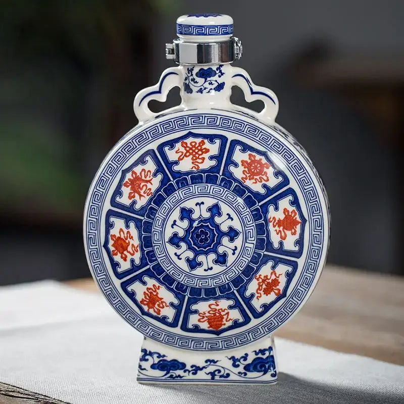 A round white eight treasures ceramic vase with blue and red traditional designs and a silver metal cap for living room decor