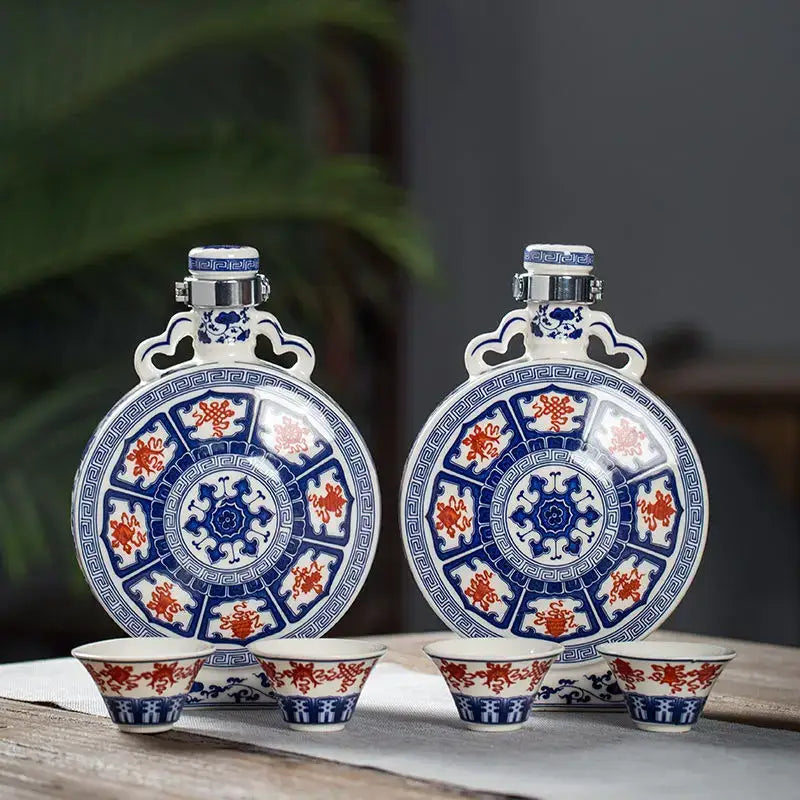 Pair of blue and red porcelain hip flasks with matching cups featuring intricate traditional white eight treasures ceramic patterns