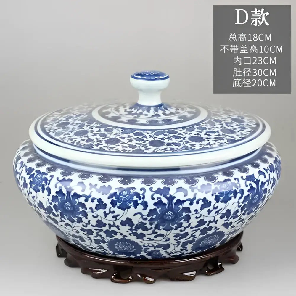 Blue and white floral ceramic tea caddy jar with intricate patterns and matching lid on ornate wooden base for decor