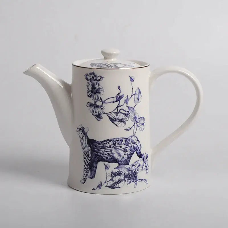 White ceramic teapot with blue floral and spotted cat design and gold-trimmed lid from decorbites kitchenware dining experience set