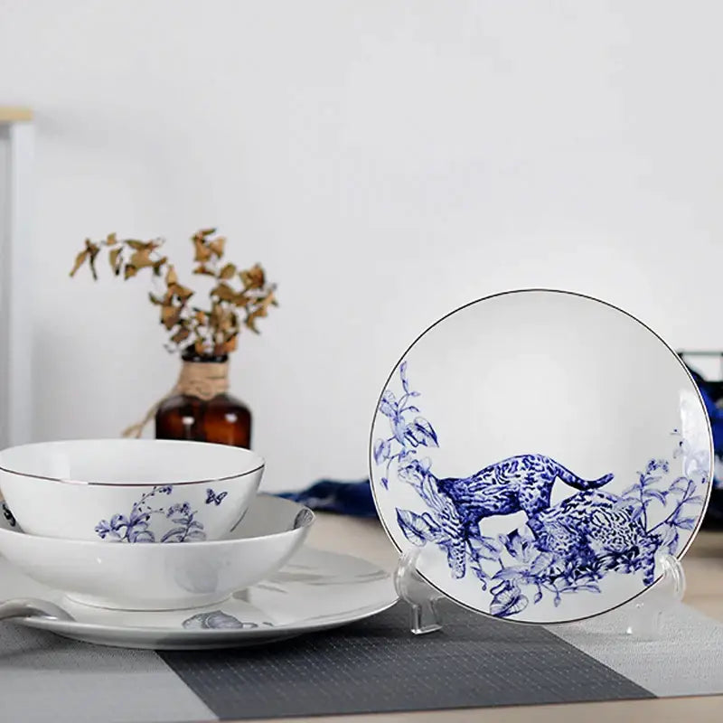 White ceramic fruit plate with blue hand-painted leopard design and black rim from decorbites kitchenware dining experience set