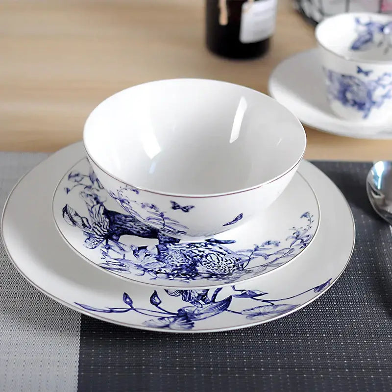 White ceramic fruit plate with blue floral and butterfly patterns and gold rim from decorbites kitchenware dining experience set