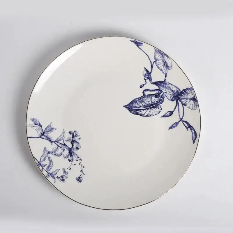 A white ceramic fruit plate with blue floral and leaf patterns from decorbites kitchenware dining experience set