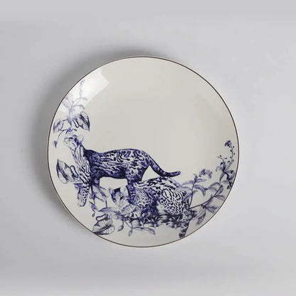 A white ceramic fruit plate with blue spotted cats and foliage illustration with metallic rim from Decorbites kitchenware dining experience set