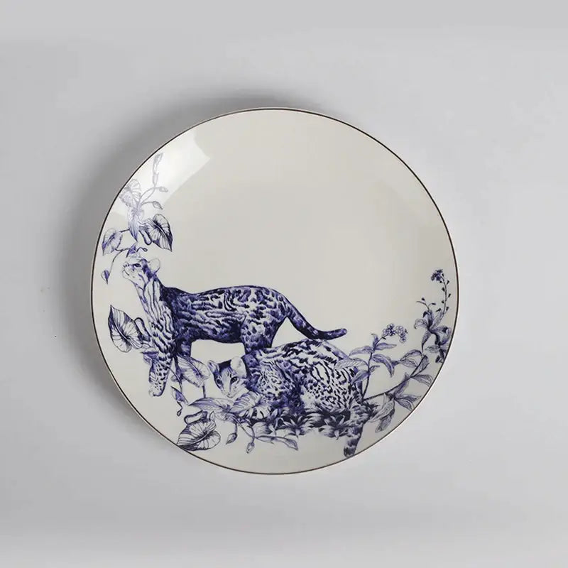 A white ceramic fruit plate with blue spotted cats and foliage illustration with metallic rim from Decorbites kitchenware dining experience set