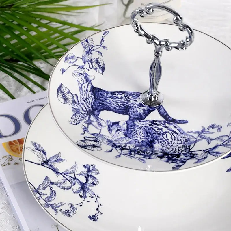White ceramic two-tier serving tray with blue hand-painted cat and foliage design and silver-toned handle for decorbites kitchenware dining experience