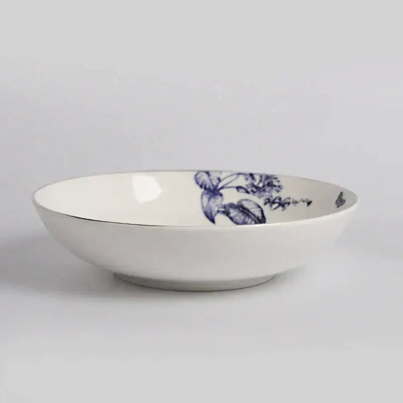A white ceramic bowl with blue floral pattern and gold rim from decorbites kitchenware fruit plates dining experience set