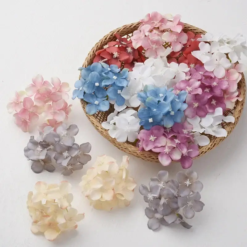 A woven basket with 30pcs decorbites hydrangea flowers in soft pastel blue white pink and gray for living room decor