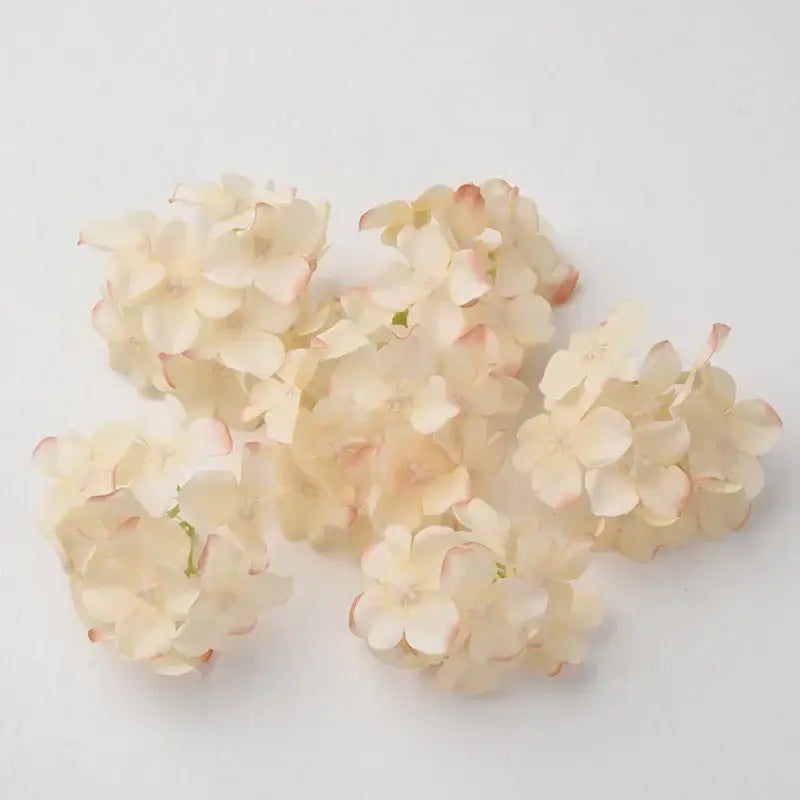 Delicate cream and pink tipped decorbites hydrangea flowers crafted from synthetic material for wedding living room decor