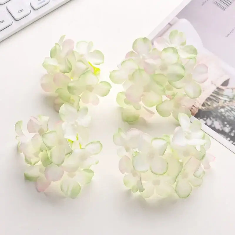 Delicate pastel blue and white decorbites hydrangea flowers made of lightweight synthetic fabric for wedding decor