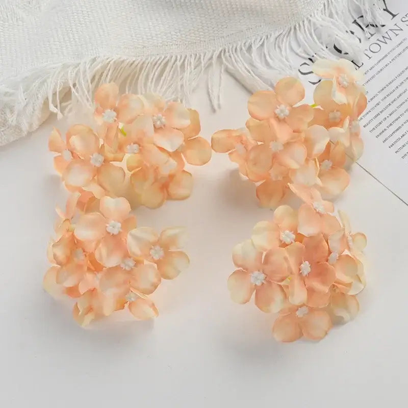Delicate peach-colored decorbites hydrangea flowers with white centers for wedding decor and living room accents